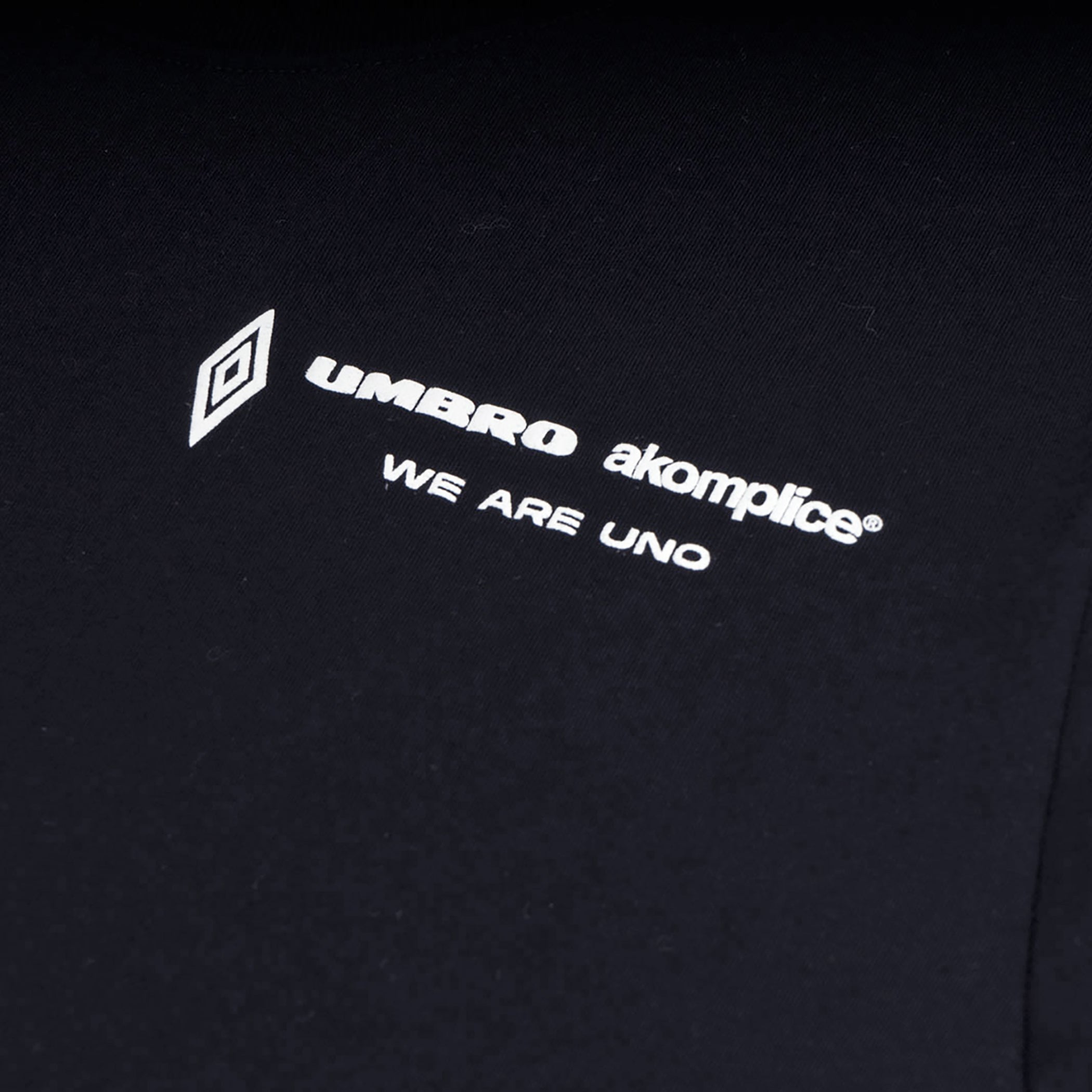 UMBRO x AKOMPLICE MENS WE ARE UNO S/S TSHIRT